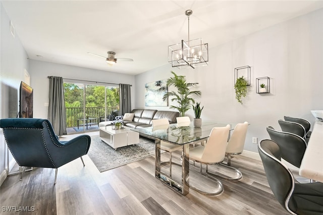 9175 Celeste Dr Unit 305, Naples, FL 34113 - living room featuring a chandelier, wood finished floors, and a ceiling fan
