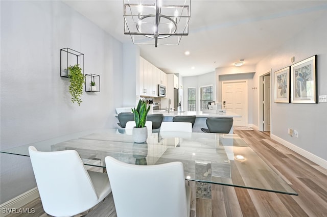 9175 Celeste Dr Unit 305, Naples, FL 34113 - dining space featuring a chandelier, wood finished floors, and recessed lighting