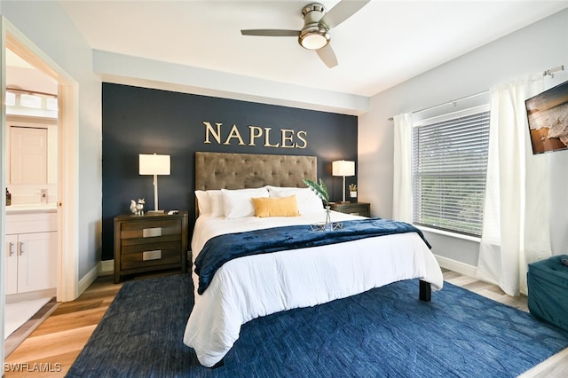 9175 Celeste Dr Unit 305, Naples, FL 34113 - bedroom with wood finished floors, a ceiling fan, and connected bathroom