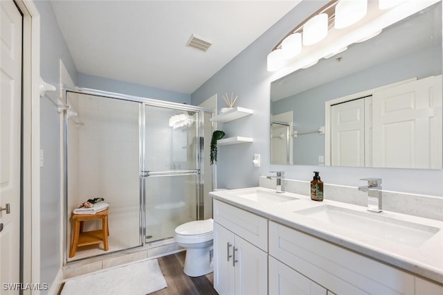 9175 Celeste Dr Unit 305, Naples, FL 34113 - bathroom featuring double vanity, a stall shower, and wood finished floors
