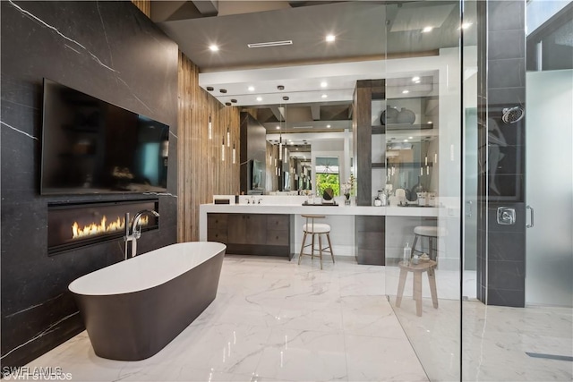 10411 Via Parma Way, Miromar Lakes, FL 33913 - bathroom with marble tiled floors, a soaking tub, vanity, a shower stall, and recessed lighting