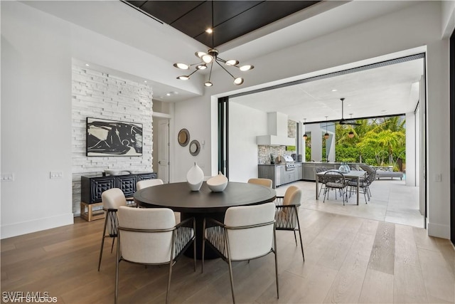 10411 Via Parma Way, Miromar Lakes, FL 33913 - dining room featuring a chandelier and wood finished floors