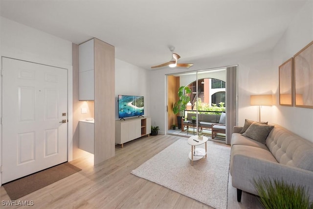 1170 Reserve Way Unit 107, Naples, FL 34105 - living room with light wood-style floors and a ceiling fan