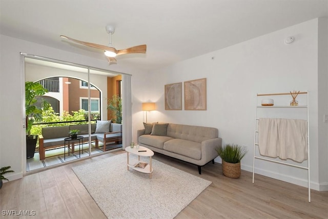 1170 Reserve Way Unit 107, Naples, FL 34105 - living area featuring light wood-style flooring and ceiling fan