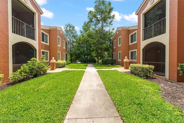 1170 Reserve Way Unit 107, Naples, FL 34105 - surrounding community featuring a lawn