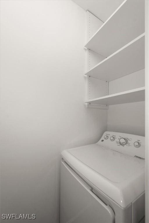 1170 Reserve Way Unit 107, Naples, FL 34105 - washroom featuring washer / dryer