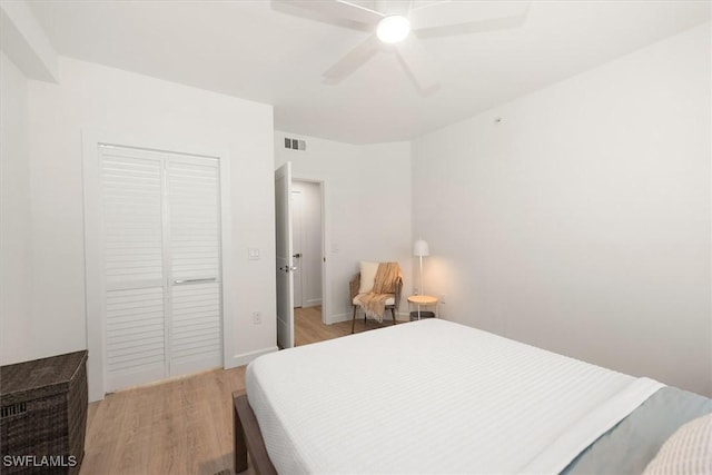 1170 Reserve Way Unit 107, Naples, FL 34105 - bedroom featuring light wood-style floors, a closet, and a ceiling fan