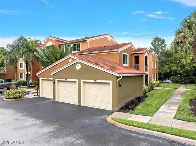 1170 Reserve Way Unit 107, Naples, FL 34105 - mediterranean / spanish-style home featuring a tiled roof, stucco siding, and a front lawn