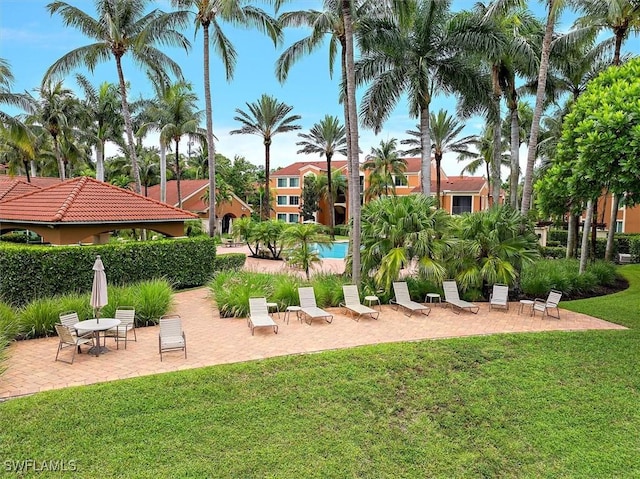 1170 Reserve Way Unit 107, Naples, FL 34105 - surrounding community featuring a yard and a patio area