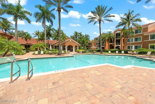 1170 Reserve Way Unit 107, Naples, FL 34105 - community pool with a patio area
