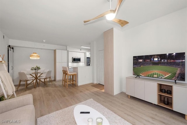 1170 Reserve Way Unit 107, Naples, FL 34105 - living area featuring light wood-type flooring and ceiling fan
