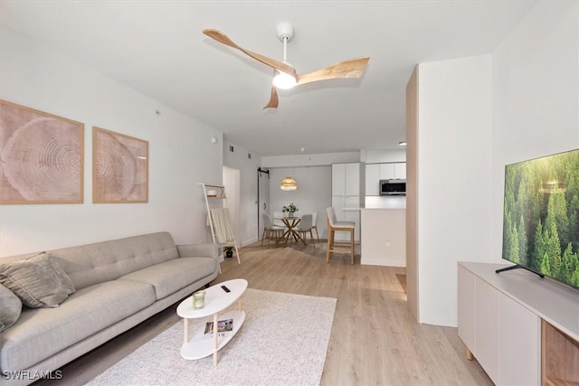 1170 Reserve Way Unit 107, Naples, FL 34105 - living area featuring light wood-style floors and a ceiling fan