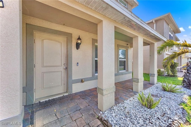 10329 Canal Brook Ln, Lehigh Acres, FL 33936 - entrance to property with stucco siding and a porch