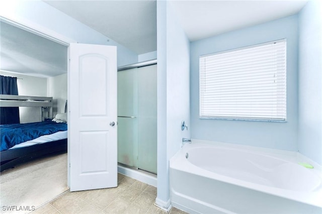 10329 Canal Brook Ln, Lehigh Acres, FL 33936 - full bathroom with ensuite bathroom, a bath, a stall shower, and tile patterned floors