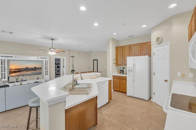 3781 Costa Maya Way Unit 101, Estero, FL 33928 - kitchen featuring white appliances, a center island with sink, a ceiling fan, light countertops, and recessed lighting