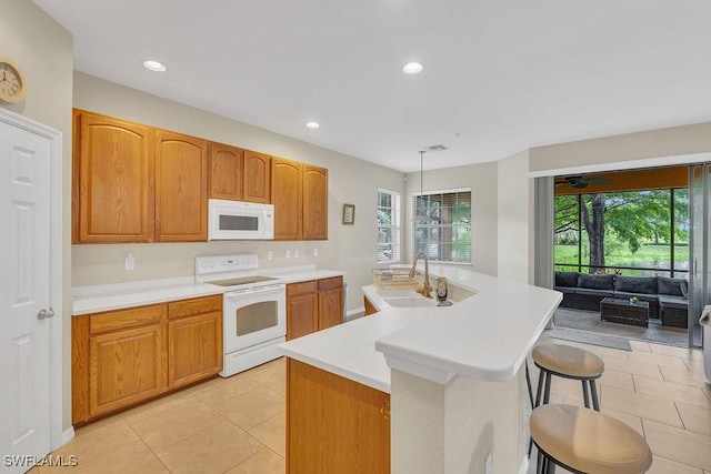 3781 Costa Maya Way Unit 101, Estero, FL 33928 - kitchen with white appliances, light countertops, light tile patterned floors, an island with sink, and recessed lighting