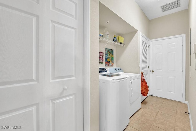 3781 Costa Maya Way Unit 101, Estero, FL 33928 - laundry area featuring washer and dryer and light tile patterned flooring
