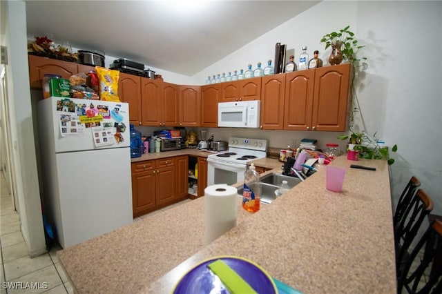 4856/4858 24th St SW, Lehigh Acres, FL 33993 - kitchen featuring white appliances, lofted ceiling, light countertops, light tile patterned flooring, and a peninsula