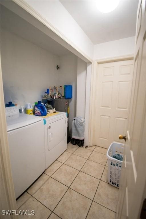 4856/4858 24th St SW, Lehigh Acres, FL 33993 - laundry area with washer and clothes dryer and light tile patterned flooring