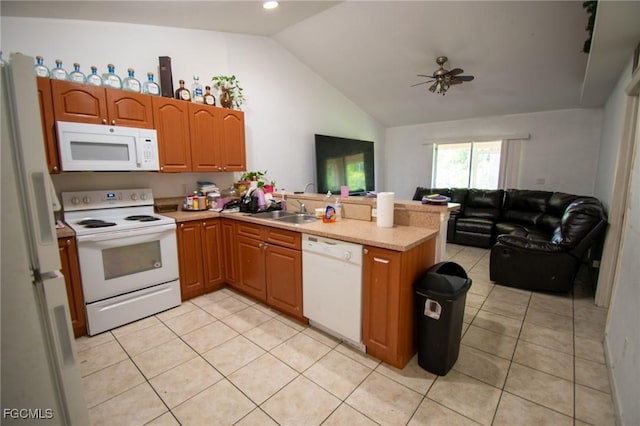 4856/4858 24th St SW, Lehigh Acres, FL 33993 - kitchen featuring white appliances, a peninsula, lofted ceiling, open floor plan, and light tile patterned floors