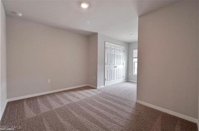 15141 Wildflower Cir, Naples, FL 34119 - carpeted empty room with baseboards and a smoke detector
