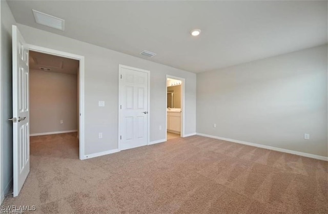 15141 Wildflower Cir, Naples, FL 34119 - unfurnished bedroom with light colored carpet, recessed lighting, and ensuite bathroom