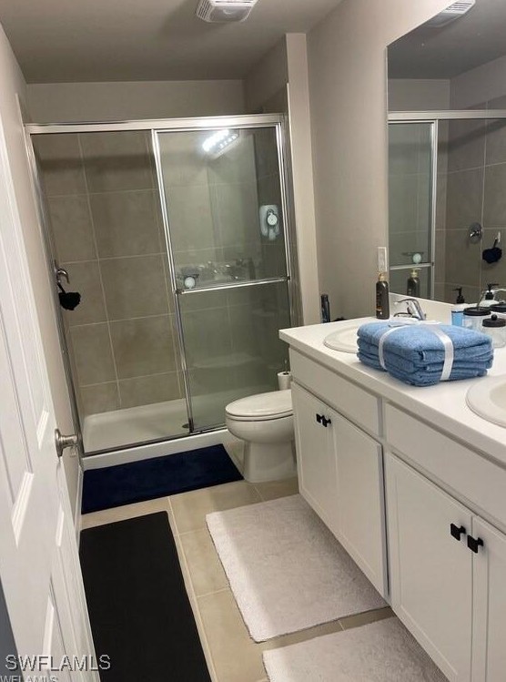 15141 Wildflower Cir, Naples, FL 34119 - full bath featuring tile patterned flooring, double vanity, and a stall shower