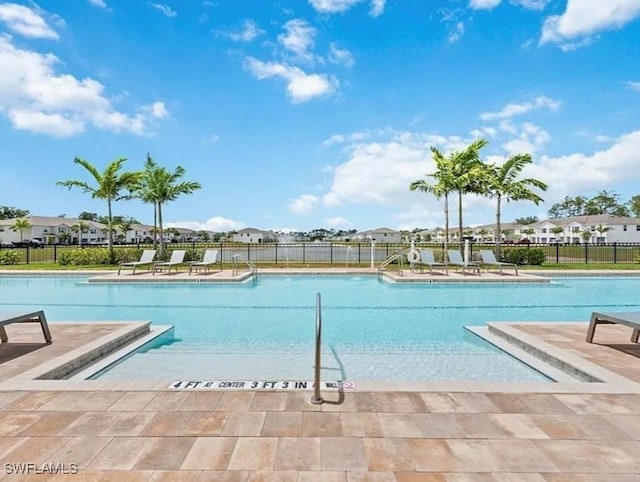 15141 Wildflower Cir, Naples, FL 34119 - community pool featuring a patio and a residential view