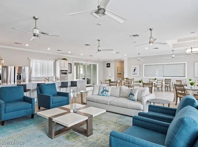 15141 Wildflower Cir, Naples, FL 34119 - living room featuring a ceiling fan, recessed lighting, and crown molding