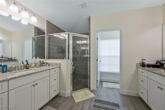 2922 20th St SW, Lehigh Acres, FL 34120 - full bathroom featuring a shower stall, vanity, and wood finished floors
