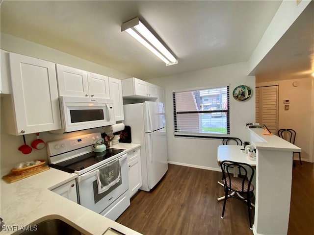 5735 Foxlake Dr Unit 1, North Fort Myers, FL 33917 - kitchen featuring white appliances, light countertops, and dark wood finished floors