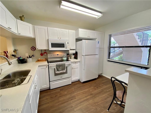5735 Foxlake Dr Unit 1, North Fort Myers, FL 33917 - kitchen with white appliances, white cabinets, dark wood finished floors, and light countertops