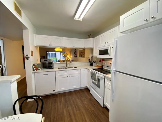 5735 Foxlake Dr Unit 1, North Fort Myers, FL 33917 - kitchen featuring white appliances, dark wood-style flooring, white cabinets, and light countertops