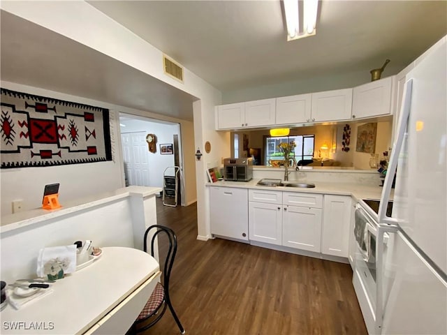 5735 Foxlake Dr Unit 1, North Fort Myers, FL 33917 - kitchen with white appliances, dark wood finished floors, light countertops, and white cabinets