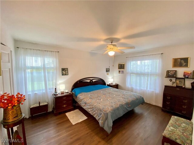 5735 Foxlake Dr Unit 1, North Fort Myers, FL 33917 - bedroom with dark wood-style flooring and a ceiling fan