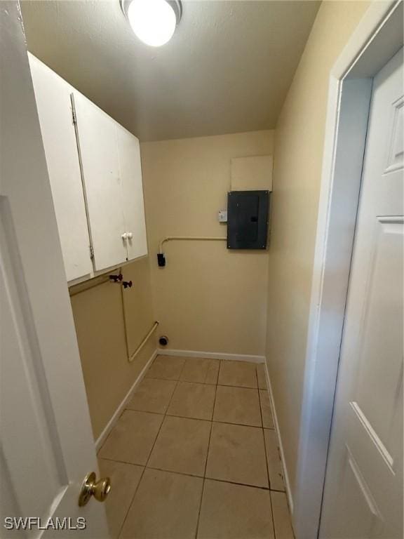 401 W Oregon Rd, Lehigh Acres, FL 33971 - laundry room with cabinet space, electric panel, and light tile patterned floors
