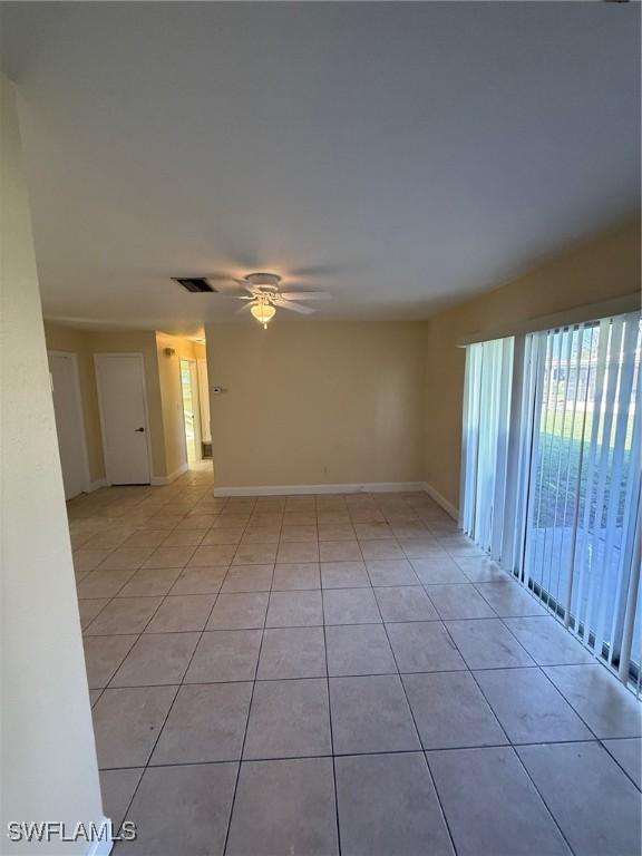 401 W Oregon Rd, Lehigh Acres, FL 33971 - spare room with light tile patterned flooring and a ceiling fan