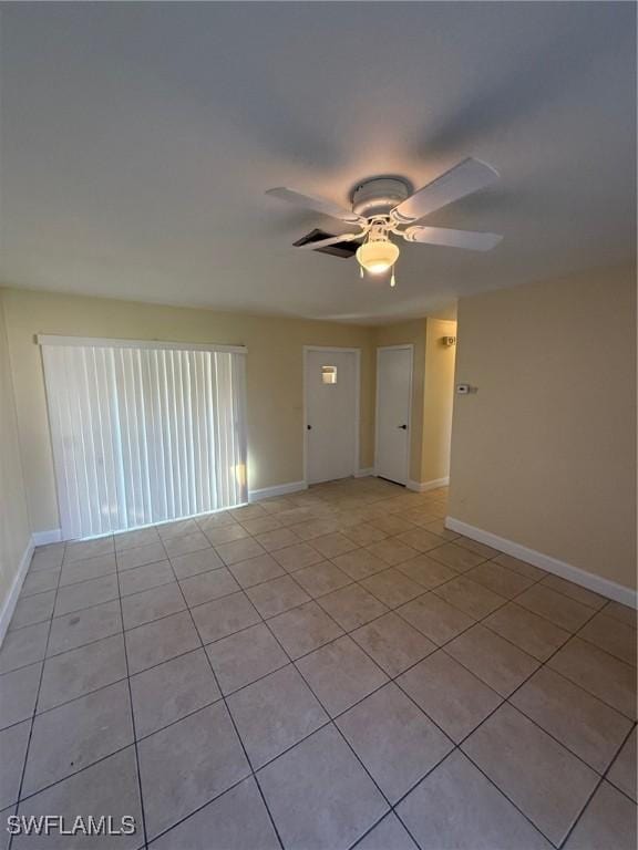 401 W Oregon Rd, Lehigh Acres, FL 33971 - empty room with a ceiling fan and light tile patterned flooring