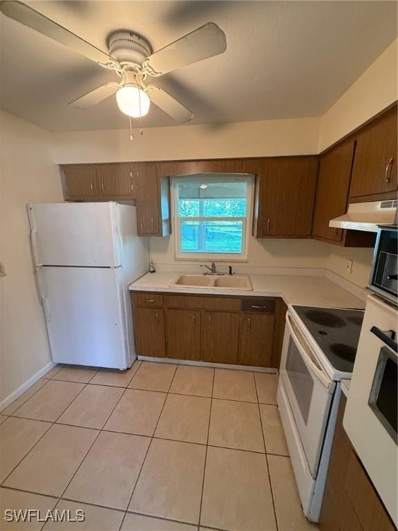 401 W Oregon Rd, Lehigh Acres, FL 33971 - kitchen featuring white appliances, under cabinet range hood, light countertops, light tile patterned floors, and ceiling fan