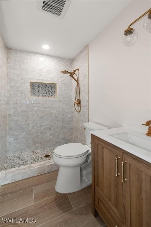 8336 Lagoon Rd, Fort Myers Beach, FL 33931 - full bath with a tile shower, vanity, and wood finished floors
