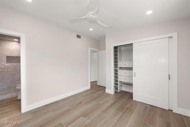 8336 Lagoon Rd, Fort Myers Beach, FL 33931 - unfurnished bedroom featuring light wood-style flooring, a closet, connected bathroom, recessed lighting, and a ceiling fan