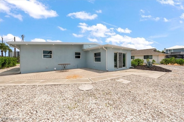 8336 Lagoon Rd, Fort Myers Beach, FL 33931 - back of house featuring stucco siding and a patio