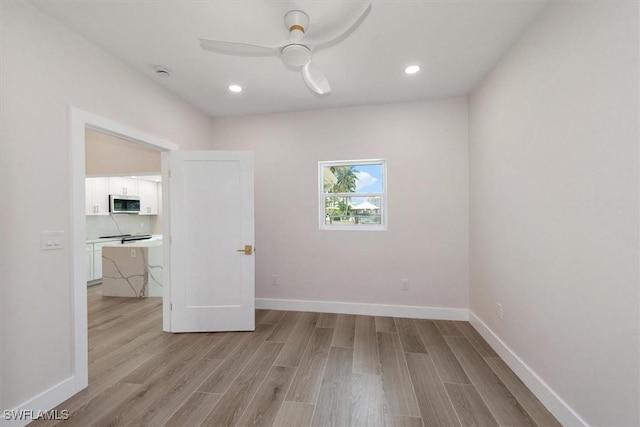 8336 Lagoon Rd, Fort Myers Beach, FL 33931 - unfurnished bedroom featuring light wood finished floors, recessed lighting, and ceiling fan