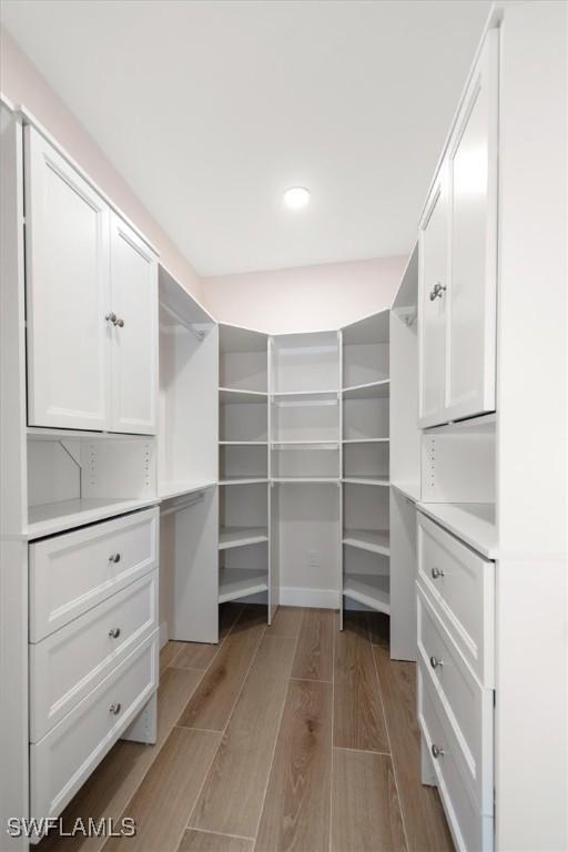 8336 Lagoon Rd, Fort Myers Beach, FL 33931 - walk in closet featuring light wood finished floors