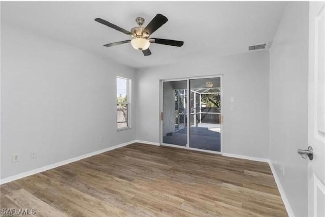 609 SW 22nd St, Cape Coral, FL 33991 - spare room featuring healthy amount of natural light, wood finished floors, and a ceiling fan