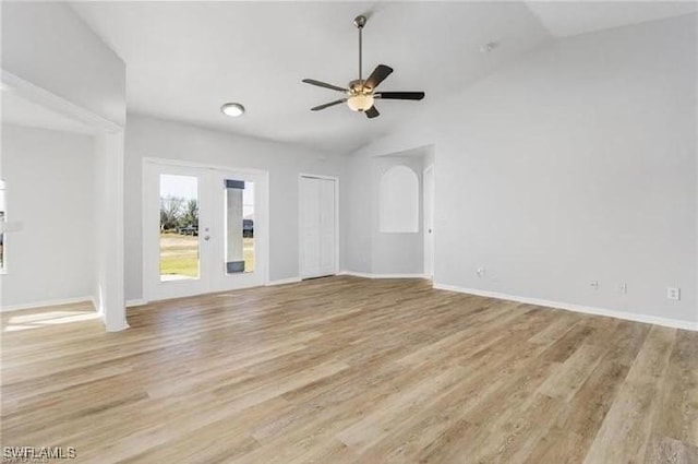 609 SW 22nd St, Cape Coral, FL 33991 - unfurnished living room with light wood finished floors, ceiling fan, vaulted ceiling, and french doors