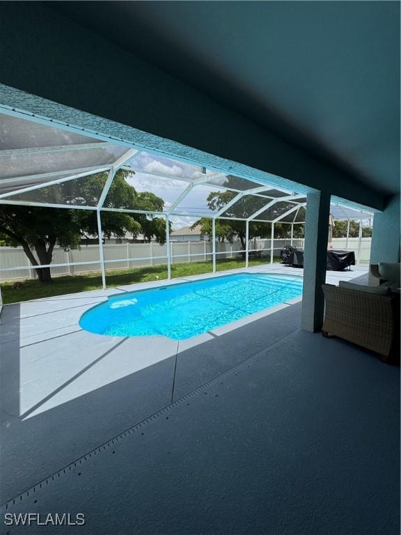 609 SW 22nd St, Cape Coral, FL 33991 - view of swimming pool with a fenced backyard, a patio area, and a lanai