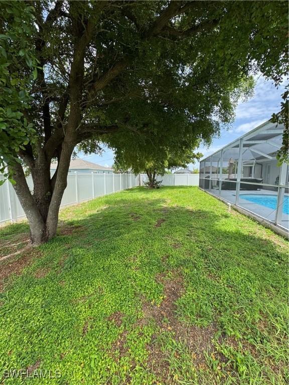 609 SW 22nd St, Cape Coral, FL 33991 - fenced backyard featuring glass enclosure