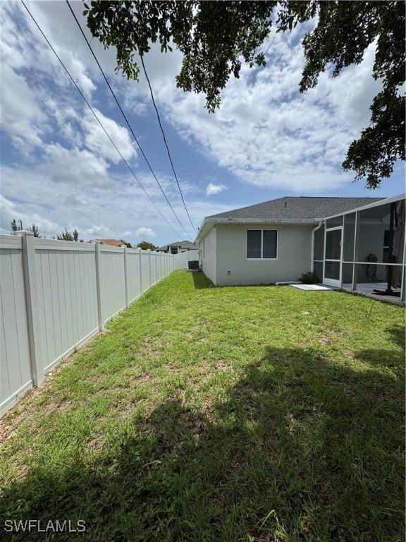 609 SW 22nd St, Cape Coral, FL 33991 - fenced backyard with a sunroom