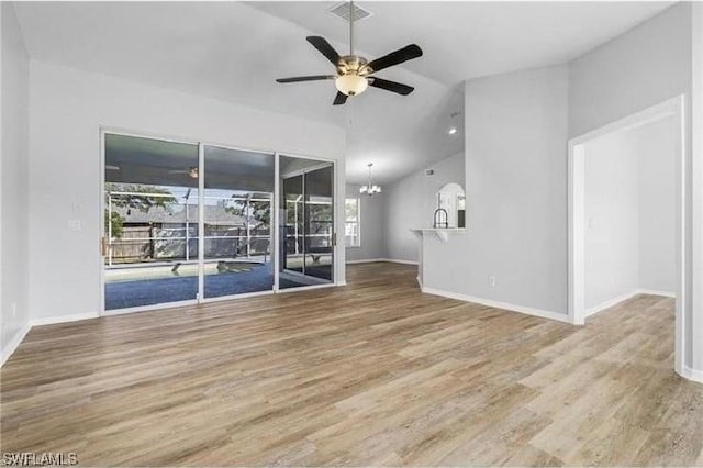 609 SW 22nd St, Cape Coral, FL 33991 - empty room featuring lofted ceiling, a chandelier, a ceiling fan, and wood finished floors